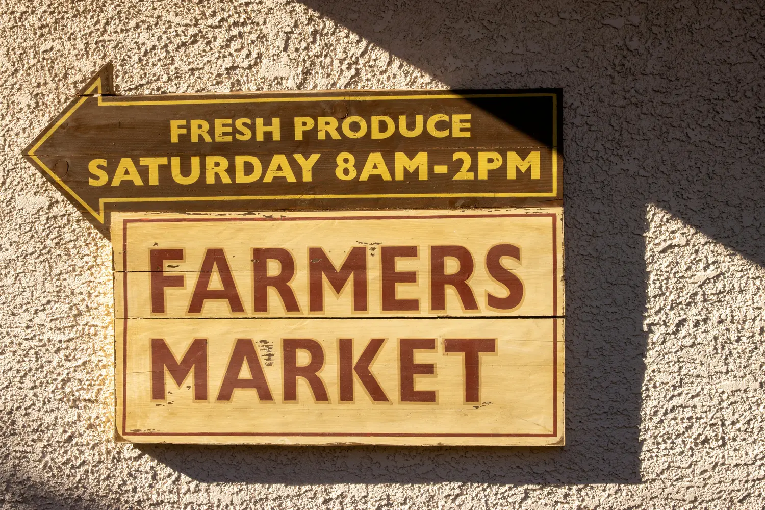 Hand-painted farmers market sign in warm afternoon light